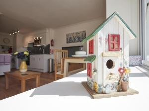 een speelgoedvogelhuisje bovenop een tafel bij 1 Bed in Keswick SZ468 in Keswick