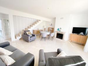 a living room with a couch and a table at Casa Rostam - Duplex avec Terrasses - Ferragudo in Ferragudo