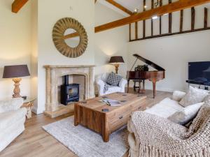 a living room with a fireplace and a piano at 3 Bed in Thetford 83020 