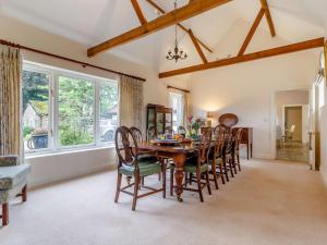 a dining room with a wooden table and chairs at 3 Bed in Thetford 83020 