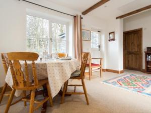 a dining room with a table and chairs and a window at 1 Bed in Borrowdale SZ163 in Keswick