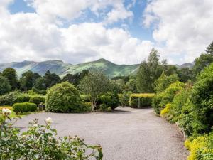 a garden with mountains in the background at 1 Bed in Borrowdale SZ163 in Keswick
