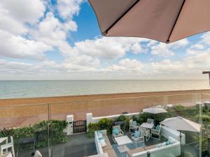 a view of the beach from the balcony of a resort at 1 Bed in Hythe 89970 in Hythe