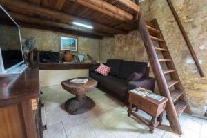 un soggiorno con divano e tavolo di Rustic studio with private pool and private garden a Biniali