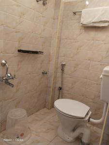 a bathroom with a toilet and a shower at RedFox Hotel-T.Nagar in Chennai