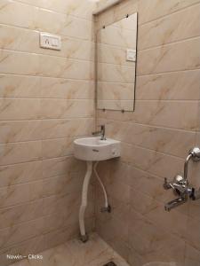 a bathroom with a sink and a mirror at RedFox Hotel-T.Nagar in Chennai