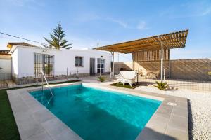 a swimming pool in the backyard of a house at Casa la Viña in Chiclana de la Frontera