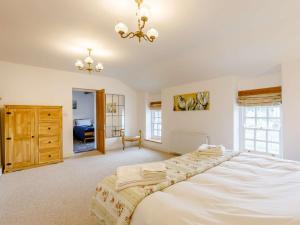 a bedroom with a large bed and a chandelier at 3 Bed in Coleford 89806 in Coleford