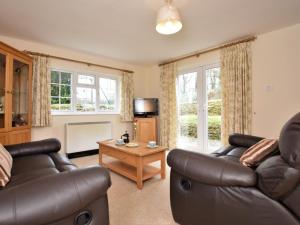 a living room with two leather couches and a table at 7 Bed in Exmoor 83059 in Parracombe
