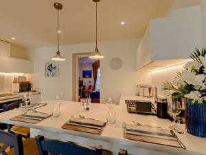 a kitchen with a table with wine glasses on it at 1 Bed in Hythe 89967 in Hythe