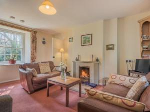 a living room with two couches and a fireplace at 4 Bed in Patterdale SZ170 in Patterdale