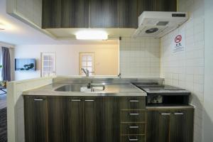 a kitchen with a sink and a stove at 37th Matsui Building 1002 - Vacation STAY 14736 in Sapporo