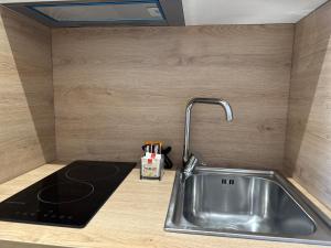 a kitchen sink with a faucet on a counter at Arial Lofts in Vlorë