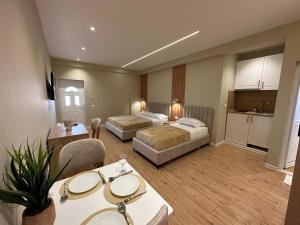 a hotel room with two beds and a kitchen at Arial Lofts in Vlorë