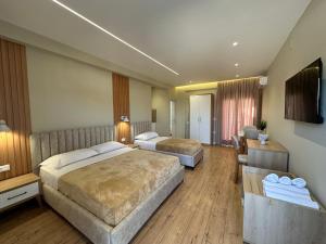 a hotel room with two beds and a television at Arial Lofts in Vlorë