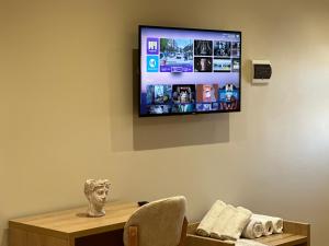 a flat screen tv hanging on a wall in a room at Arial Lofts in Vlorë