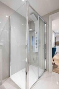 a glass shower in a room with at Wanstead, Escape London in London-Luxury 2 Bed in London