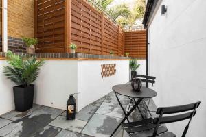 a small patio with a table and two chairs at Wanstead, Escape London in London-Luxury 2 Bed in London