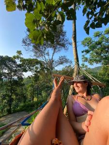 two women laying in a hammock in the jungle at Little wood villa Doluwa in Kandy