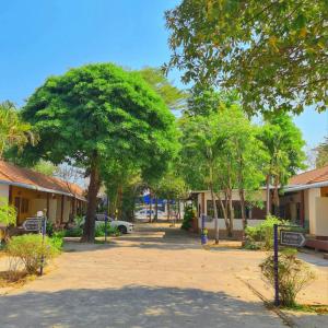 a street in a town with trees and houses at โรงแรมวรรณิดา การ์เด้น รีสอร์ท in Ban Dong Hua Khot (1)