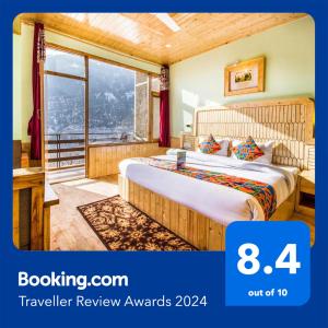 a hotel room with a bed and a window at FabExpress Shami Inn Naggar Road in Manāli