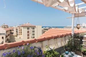 a view of a city from a balcony with flowers at Charming New Apt in Jaffa Near Sea in Tel Aviv