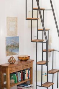 a book shelf with a ladder next to a bookcase at Charming New Apt in Jaffa Near Sea in Tel Aviv
