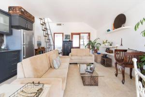 a living room with a couch and a table at Charming New Apt in Jaffa Near Sea in Tel Aviv +21 photos