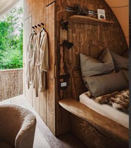 a bed in a room with a wooden wall at deichkind country loft in Achim