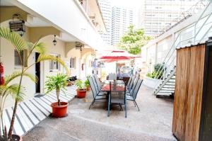 a patio with a table and chairs and plants at CASA NATALIA - Guesthouse in Luanda