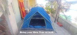 ein blaues Zelt an der Seite eines Gebäudes in der Unterkunft Everest Home Stay Apartment in Pātan