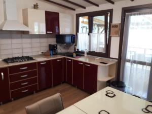a kitchen with brown cabinets and a counter top at Olga house Deva in Deva