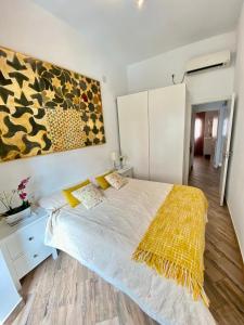 ein Schlafzimmer mit einem Bett und einem Wandgemälde in der Unterkunft Apartamento 4pax en pleno centro Alfalfa in Sevilla