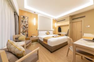 a hotel room with a bed and a desk at Glenmarie Hotel and Golf Resort in Shah Alam +63 photos