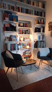 a living room with a book shelf filled with books at Le Manivert in Vitry-Laché