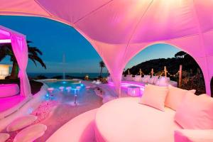 a pink tent with a couch and a swimming pool at Ibiza Style Barcelona in Badalona
