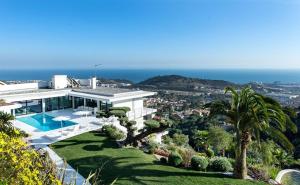 a large white house with a swimming pool at Ibiza Style Barcelona in Badalona