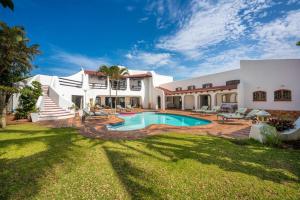 an exterior view of a house with a swimming pool at Lalaria Ocean Villa in Ballito