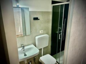 a bathroom with a toilet and a sink and a shower at Il Castello Di Venere in Rota d'Imagna