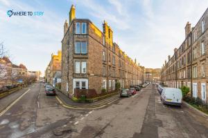 an empty street with cars parked in front of buildings at Marvellous 2 bed apartment Edinburgh in Edinburgh