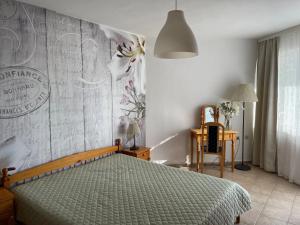 a bedroom with a bed with a green comforter at Apartments Panorama Ravda in Ravda