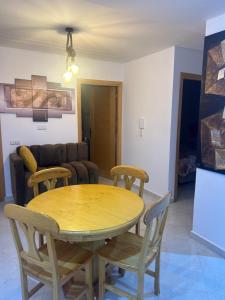 a dining table and chairs in a living room at le Lys apprt Oujda in Oujda