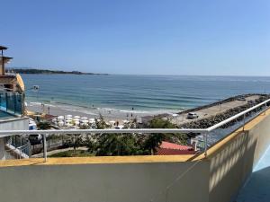 a view of the beach from the balcony of a building at Apartments Panorama Ravda in Ravda