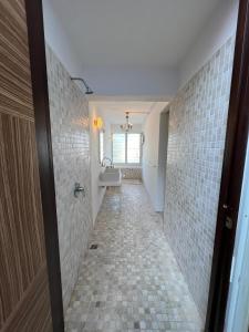 a bathroom with a walk in shower and a sink at myRoom Georgetown at Pulau Tikus Market, Georgetown, Gurney Bay in George Town