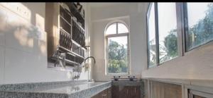a large kitchen with a sink and a window at Calangute Cosy 1 bhk Apartment in Calangute
