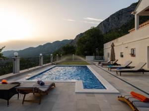 una piscina en un patio con montañas al fondo en Villa Dragić, en Pridvorje