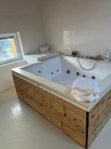 a white bathroom with a tub in a room at Charming 6 bed chalet in 4 Valleés in Iserables