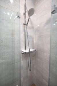 a shower with a shower head in a bathroom at U Sysi in Kudowa-Zdrój