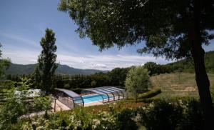 a house with a swimming pool in a field at Basilicata Foresteria di San Leo Villa Esclusiva con Piscina in Trivigno
