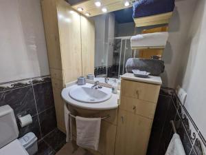 a bathroom with a sink and a mirror at Valencia Canyamelar Beach Apartments in Valencia
